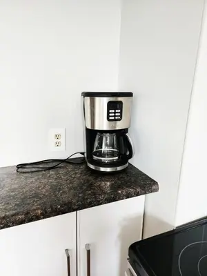 a coffee maker sitting on a counter in a kitchen at House in Edmonton