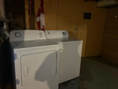 a white washer and dryer sitting in a room at Vancouver Airport Rooms - Free Parking, Fast WiFi, Near Transit in Vancouver