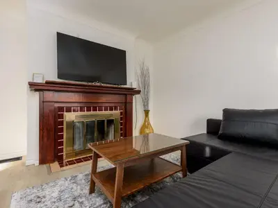 a living room with a couch and a fireplace at Cozy 2BR 1BA Retreat in Vibrant Vancouver in Vancouver