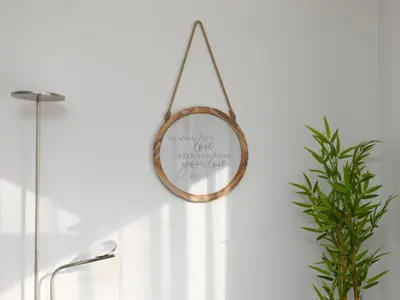 a mirror hanging on a wall with a plant at Cozy 2BR 1BA Retreat in Vibrant Vancouver in Vancouver