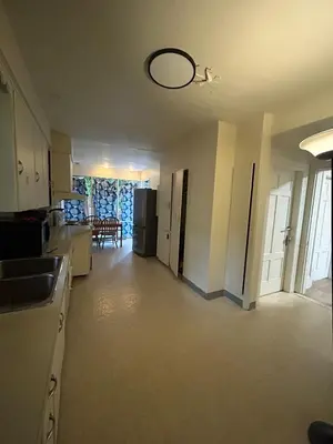 an empty kitchen and living room of a house at Vancouver Budget Rooms Near Beach & Transit - Fast WiFi & Free Parking in Vancouver