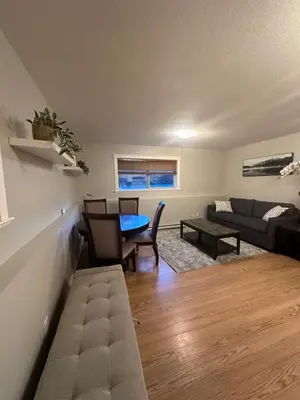 a living room with a table and a couch at 2-Bedroom Private Suite near VIU in Nanaimo