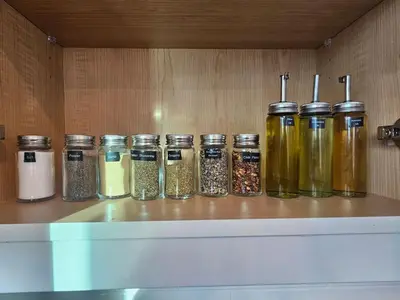 a row of jars of spices sitting on a shelf at Comfortable Home Near Hospitals and Parks in Calgary
