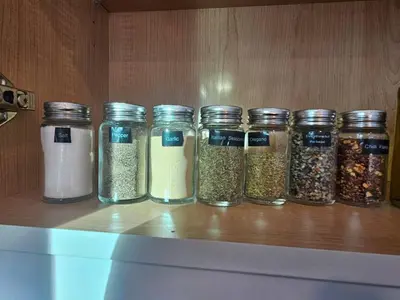 a row of jars of spices on a shelf at Comfortable Home Near Hospitals and Parks in Calgary