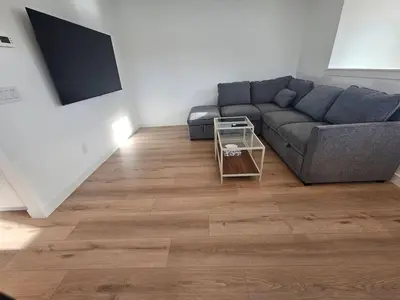 a living room with a couch and a table at Comfortable Home Near Hospitals and Parks in Calgary