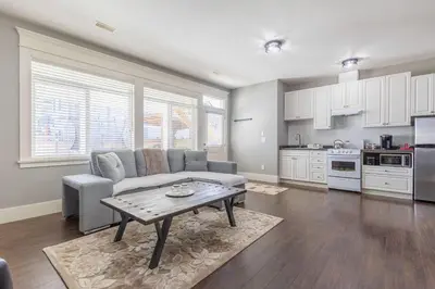 a living room with a couch and a table at Beautiful abode in Abbotsford in Abbotsford