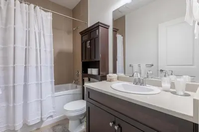 a bathroom with a sink and a toilet and a tub at Beautiful abode in Abbotsford in Abbotsford