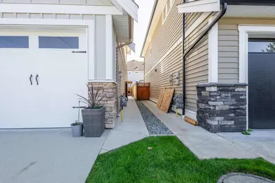 a house with a white garage door and a driveway at Beautiful abode in Abbotsford in Abbotsford