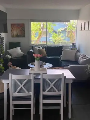 a living room with a table and two chairs at Quiet-comfy 3 bedroom house on a tree lined street in Kitsilano in Vancouver
