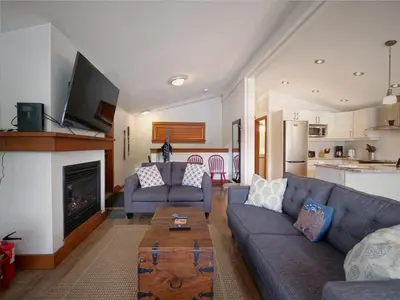 a living room with a couch and a fireplace at Wickham's Wake - 3BR Oceanfront - pet friendly in Port Renfrew