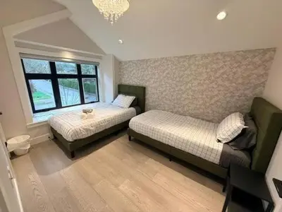a bedroom with two beds and a window at YVR3106 | Cozy 3BR in Central Vancouver | 15 min to Downtown in Vancouver