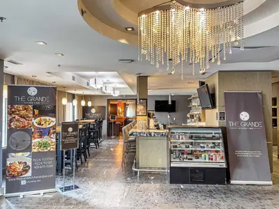 a restaurant with a food counter and a buffet at Stunning Penthouse with Mtn Views Hot Tub and Pool in Canmore