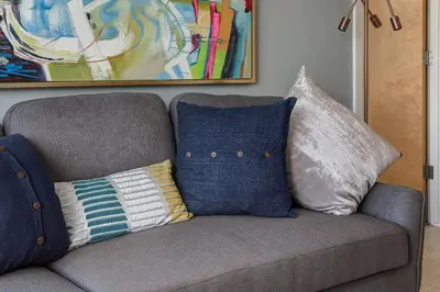 a couch with pillows on it in a living room at Stylish Mountain View Condo with Gym in Canmore