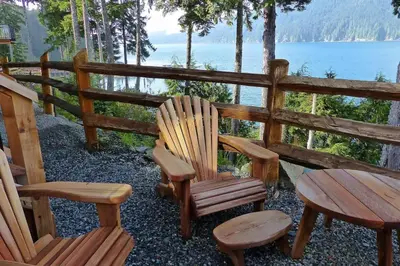 a group of chairs and a table and a table and bench at Oceanfront Suite with Hot Tub - No Pets - Sleep 4 in Port Renfrew