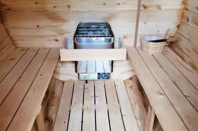 an inside view of a stove in a wooden cabin at Explorer's Retreat Sauna & Bunkhouse & Fire pit in Port Renfrew
