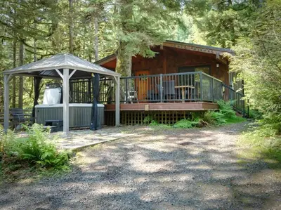a cabin in the woods with a gazebo at Hot tub Oasis Among Trees - Pet Friendly in Port Renfrew