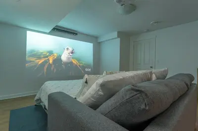 a living room with a painting of a dog on a wall at Cozy Large Family Home near Lake, AC, Full Kitchen in Calgary
