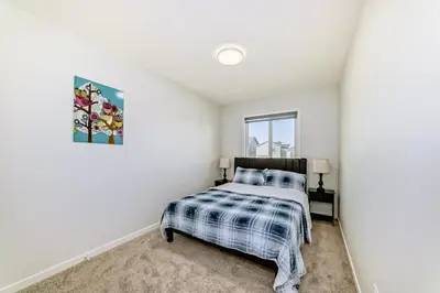 a bedroom with a bed and a window at Cozy 3 beds 2 and half baths 2 Story Home in Calgary