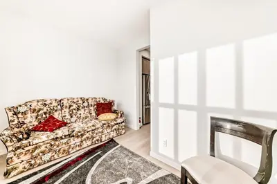 a living room with a couch and a chair at Cozy 3 beds 2 and half baths 2 Story Home in Calgary