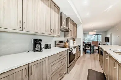 a kitchen with white counter tops and wooden cabinets at Cozy 3 beds 2 and half baths 2 Story Home in Calgary