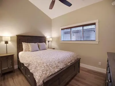 a bedroom with a large bed and a window at Amazing Marina & Oceanfront View - Pet Friendly - Sleeps 6 in Port Renfrew