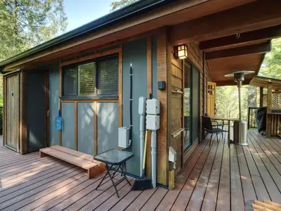 a screened in porch of a house at Hot Tub - Pet Friendly - Cozy Escape with Fire Pit in Port Renfrew
