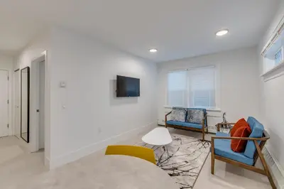 a living room with two chairs and a tv at Spacious Apartment Fully Equipped in Prime Location in Vancouver
