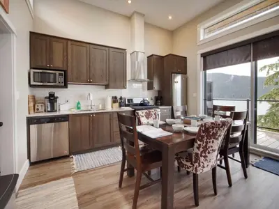 a kitchen with a table and chairs and a dining room at Amazing Oceanfront & Eagle Views pet Friendly - 2 bath in Port Renfrew