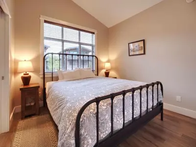 a bedroom with a large bed and a window at Amazing Oceanfront & Eagle Views pet Friendly - 2 bath in Port Renfrew