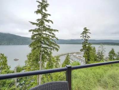 a balcony with a view of a lake at Amazing Oceanfront & Eagle Views pet Friendly - 2 bath in Port Renfrew