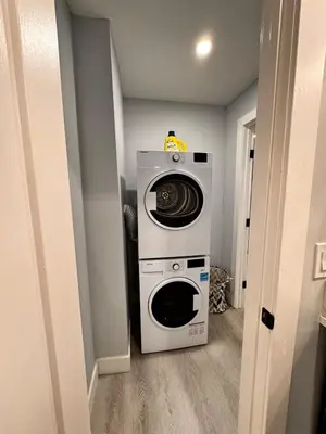 a washer and dryer in a small room at Private 1BR Basement Suite in NE Calgary in Calgary