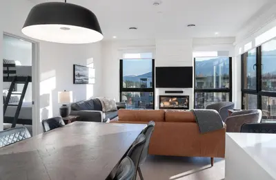a living room with a table and a couch at The Ridge - 3 Bedroom Condo - Roof Top Hot Tub in Revelstoke