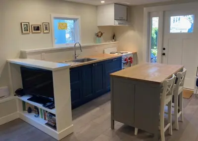 a kitchen with blue cabinets and a sink and a counter at Beautiful Oasis in prime Vancouver BC with 2 bed and patio PLUS Studio available in Vancouver