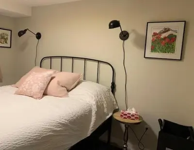 a bedroom with a bed with two lamps and a table at Beautiful Oasis in prime Vancouver BC with 2 bed and patio PLUS Studio available in Vancouver