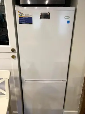 a white refrigerator in a kitchen next to a cabinet at Beautiful Oasis in prime Vancouver BC with 2 bed and patio PLUS Studio available in Vancouver