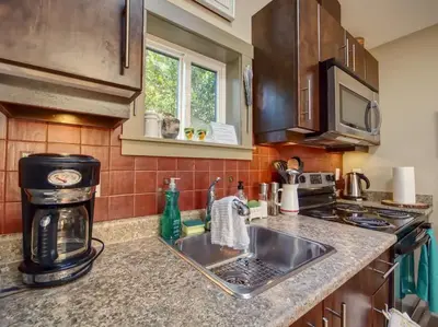 a kitchen with a sink and a coffee maker at Quiet Romantic Getaway - Non Pet Friendly in Port Renfrew