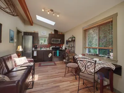 a living room with a couch and a table at Quiet Romantic Getaway - Non Pet Friendly in Port Renfrew