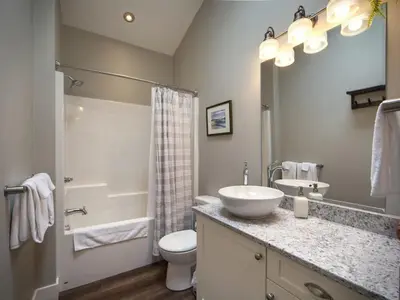 a bathroom with a white sink and a toilet at Oceanfront Marina & Mountain views- pet friendly in Port Renfrew