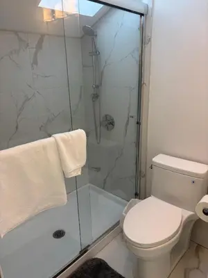 a bathroom with a shower and a toilet at Comfortable Private Room in a Shared Home in Richmond