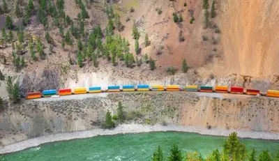 a train is crossing a bridge over a river at Lotus Hideaway in Boston Bar