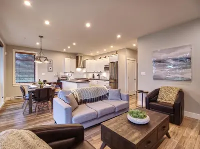 a living room with a couch and a table at The Salty Dog - Oceanfront Getaway - Great View - Pet Friendly in Port Renfrew