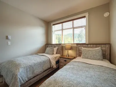 a bedroom with two beds and a window at Oceanfront & Amazing Views - Pet Friendly - 2bdrm in Port Renfrew