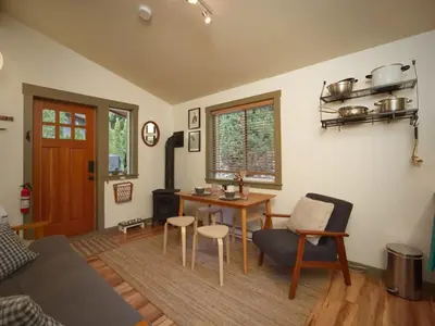 a living room with a table and a couch at The Rocky Knoll - Garden View - Pet Friendly in Port Renfrew