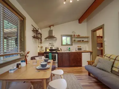 a living room with a table and a couch at The Rocky Knoll - Garden View - Pet Friendly in Port Renfrew