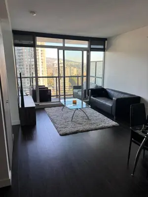 a living room with a couch and a glass table at Sleek Urban 1BR Retreat in Burnaby