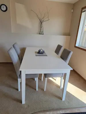 a white table and chairs in a room at Quaint Lonsdale Suite in Red Deer