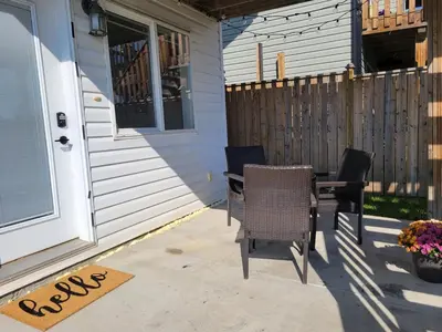 a patio with two chairs and a table next to a house at Quaint Lonsdale Suite in Red Deer