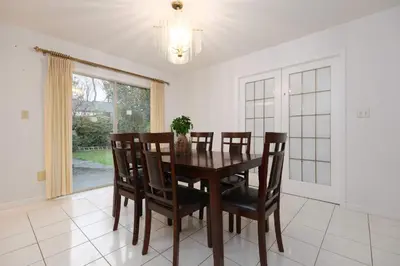 a dining room with a table and chairs and a window at Private Room with Full Amenities in Cozy House in Vancouver