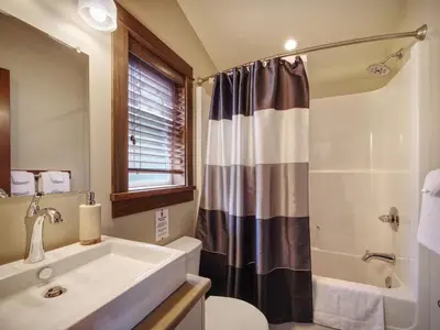 a bathroom with a sink and a toilet and a shower at Hera's Cove - Oceanfront Oasis - Pet Friendly in Port Renfrew