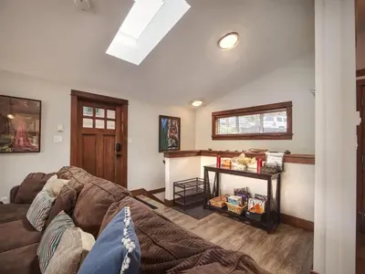 a living room with a couch and a table at Hera's Cove - Oceanfront Oasis - Pet Friendly in Port Renfrew